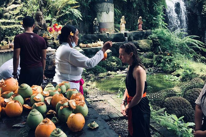 Purifications at Beji Griya Waterfalls - The pool shower wrap-up: offering, coconut blessing, and priest support
